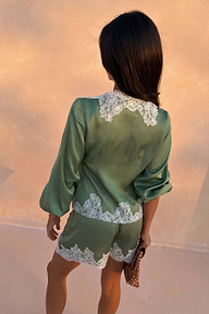 Green Lace Romi Top in soft green satin with white lace detailing and voluminous sleeves, shown from the back.