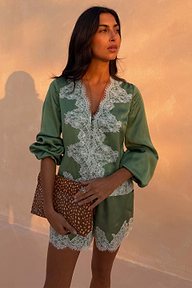 Green Lace Romi Top in green satin with contrast white lace panels and long sleeves with volume.