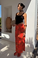 Rosie Maxi Skirt in red with a floral and leopard print, styled with a black tank top and neck scarf.