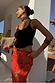Thumbnail for Red Rosie Maxi Skirt in viscose with floral and leopard prints, featuring a bias cut and paired with a black vest.