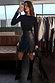 Thumbnail for Black Vegan Leather Ruffle Mini Jaspre Skirt with a ruffled hem, worn with black boots in a mirror selfie.