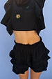 Black Ruffle Shorts with tiered lace trim and an elasticated waistband, styled as a co-ord with a matching embroidered top.