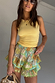 Thumbnail for Isla Ruffle Shorts featuring a multi-colour scenic print, tiered ruffles and a green lace trim.