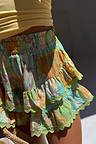 Isla Ruffle Shorts in a multi-coloured hand-painted print with tiered ruffles and green scalloped lace trim.