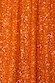 Close-up of shimmering burnt orange sequins on the Orange Sequin Dorris Skirt, capturing the light and texture.