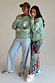 Sage Sundazed Accessible Sweatshirt with cream palm prints, HOPE graphic and concealed zips, worn by two models.