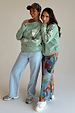 Sage Sundazed Accessible Sweatshirt with cream palm prints, HOPE graphic and concealed zips, worn by two models.