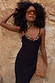 Black Sapna Dress with statement tortoiseshell ring detailing at the neckline and slim straps, styled with sunglasses.
