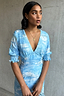 Scenery May Dress Petite in a blue Lake Como print with a deep V-neckline and shirred sleeves.