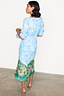 Scenery May Dress Petite in blue with an Italian Lake Como print and frilled sleeves, viewed from the back.