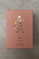 NFD Eau De Parfum 002 in a pink textured box with gold foil palm tree and celestial illustrations.