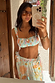 Blue Dreamer Shirred Bandeau Bikini Top with sun and palm motifs, styled with trousers in a mirror selfie.