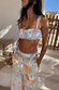Blue Dreamer Shirred Bandeau Bikini Top featuring a sun and heart motif print, styled with matching trousers.