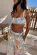 Blue Dreamer Shirred Bandeau Bikini Top featuring a sun and heart motif print, styled with matching trousers.