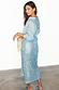 Ice Blue Sequin Jaspre Skirt in a wrap style, styled with a matching long-sleeved shirt and blue pointed flats.