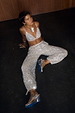 Silver Sequin Bra and matching trousers for a partywear co-ord, shown on a model sitting on a dark floor.