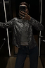 Gunmetal Alexa Sequin Cardigan in a structured silhouette, styled over a grey top and jeans for a party-ready look.