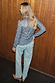 Gunmetal silver sequin Miley Shirt with long sleeves, paired with light-wash jeans and tan heels.