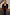 Thumbnail for Black Sequin Jumpsuit with a square neckline, styled with a blazer draped over the shoulders of a model.