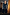 Thumbnail for Black Sequin Jumpsuit with a square neckline and flared trousers, styled with a black blazer and pointed heels.