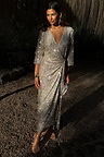 Silver Sequin Kira Wrap Dress featuring a multi-wear wrap fastening and long sleeves, styled as a maxi party dress.