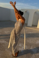 Silver Sequin Maxi Wrap Jaspre Skirt and Sequin Lily Top on a model in a sunlit outdoor setting.
