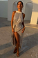 Silver sequin maxi Jaspre wrap skirt on a model in an outdoor setting with white archways.