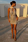 Model wearing the Silver Sequin Mini Jaspre Skirt and matching sequin top against a backdrop of white arches.
