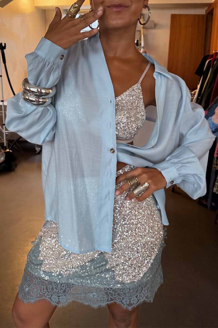 Silver Sequin Mini Maeva Skirt with a blue lace border, styled with a matching sequin top and light blue shirt.