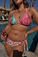 Pink and blue Beaded Embroidered Shell Triangle Top with beadwork, shown on a model for a poolside vacation look.