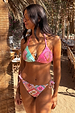 Mixed Tile Tie Side Brief with motifs designed in-house and a shell bikini top in a vacation setting.