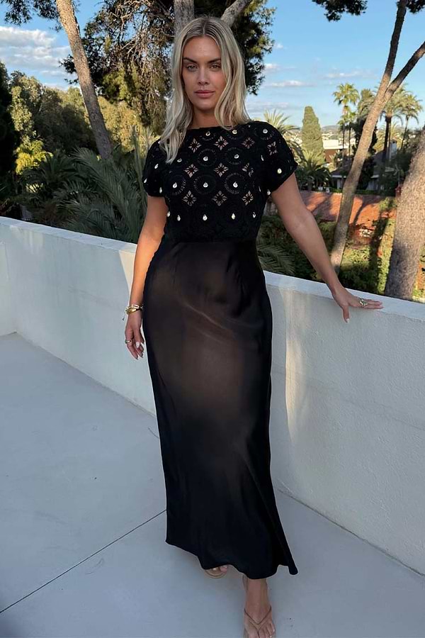 Black Crochet Shell Elodie Dress with a gold shell-embellished crochet top and a flowing satin skirt.