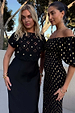 Black Crochet Shell Elodie Dress with gold shell embellishments and a satin skirt, shown on models outdoors.