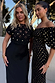 Black Crochet Shell Elodie Dress with gold shell crochet top and satin skirt, worn by a model in an outdoor setting.