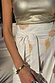 Thumbnail for Shells Jaspre Wrap Skirt in white with an orange shell print and adjustable multi-wear tie-waist.