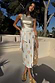 Thumbnail for Shells Jaspre Wrap Skirt with a seashell print and multi-wear tie, styled with a gold top for vacation.