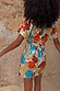 Shell Mini Wrap Dress in an abstract shell print with gold metallic detailing and flutter sleeves, seen from the back.