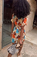 Shell Mini Wrap Dress in a multi-colour abstract shell print with gold metallic detailing, shown from the back.