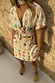 Thumbnail for Cream Shell Mini Wrap Dress with colourful seashell motifs, V-neckline and adjustable wrap tie fastening.