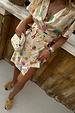 Cream Shell Mini Wrap Dress featuring multicoloured seashell motifs and a wrap tie fastening.