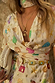 Cream Shell Mini Wrap Dress featuring multicoloured seashell motifs, gold foil and a wrap tie waist.