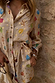 Cream Shell Elissa Shorts with a colourful shell print and gold flecks, styled as a vacation-ready co-ord.