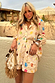 Thumbnail for Cream Shell Elissa Shorts and matching shirt with a colourful shell print and gold flecks, styled for a vacation look.