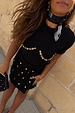 Black Crochet Shell Wrap Skirt with gold shell embellishments and tie-waist fastening, styled for a vacation look.