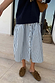 Navy Knit Jumper Dress with a blue striped cotton skirt and button-front detail, styled with loafers.