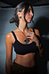 Deloris Silver Circle Earrings in textured brushed metal, styled on a model with an eye pendant and black crop top.