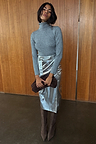 Iconic Silver Vegan Leather Jaspre Skirt styled with a grey roll neck and brown suede boots.