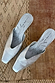Silver Wedge Mules in metallic real leather with a pointed toe and illustrated insole on a textured rug.
