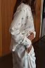 Thumbnail for White textured Ski Waffle Pyjamas with a multi-coloured ski print, featuring a long-sleeved top and side pockets.