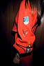 Thumbnail for Red Ski Knit Long Cardigan sleeve highlighting embroidered in-house designed ski motifs on a soft red knit.